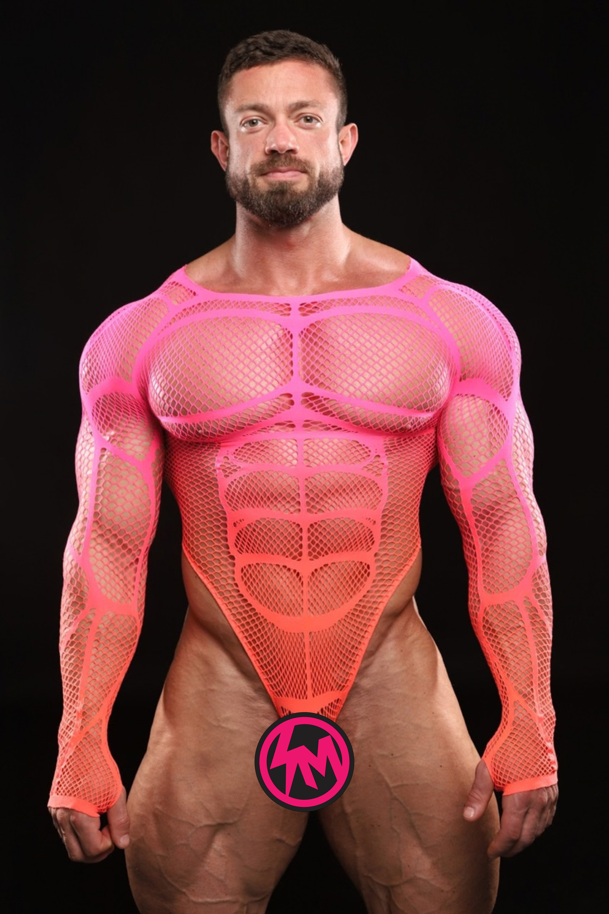 A muscular man wearing a bright neon pink mesh bodycon garment with long sleeves and a sculpted abdominal design, posed against a solid black background. A pink circular logo with an 'SM' is visible on the front of the garment.