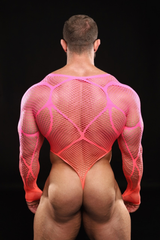 Person wearing a pink mesh outfit against a black background